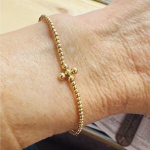 ENewton signature cross gold pattern 2mm bead bracelet. Classic signature cross